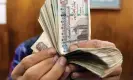  ?? Mohamed Abd El Ghany/Reuters ?? The size of the ADQ investment deal reassured the government sufficient­ly to float the Egyptian pound last month. Photograph: