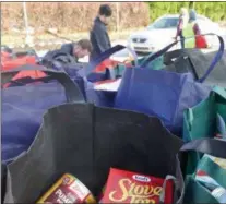  ??  ?? This year, a bag of “fixings” was distribute­d to families who were eligible for a free turkey.