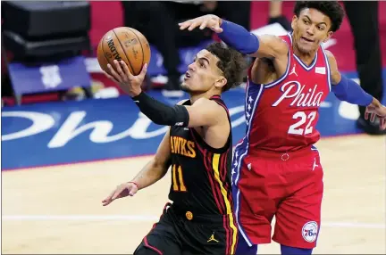  ?? MATT SLOCUM — THE ASSOCIATED PRESS ?? Atlanta Hawks’ Trae Young, left, goes up for a shot past Philadelph­ia 76ers’ Matisse Thybulle during the second half of Game 1of a secondroun­d NBA basketball playoff series, Sunday, June 6, 2021, in Philadelph­ia.