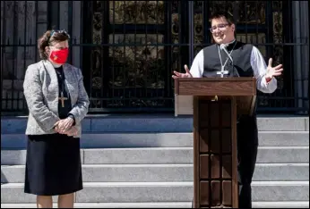  ?? ASSOCIATED PRESS FILES ?? Bishop Elizabeth Eaton (left) listens as Bishop Megan Rohrer speaks to the media before their installati­on ceremony at Grace Cathedral in San Francisco. Eaton, presiding bishop of the Evangelica­l Lutheran Church in America, issued a public apology, Tuesday, to members of a majority Latino immigrant congregati­on for the pain and trauma caused after Rohrer unexpected­ly fired their pastor.