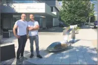  ?? Susan Dunne / Associated Press ?? Art gallery proprietor Luis Alvarez, left, and sculptor Domenic Esposito stand beside an 800-pound sculpture of a bent, burnt heroin spoon placed in front of the Stamford headquarte­rs of Purdue Pharma to protest the company’s manufactur­ing of opioids on June 22.