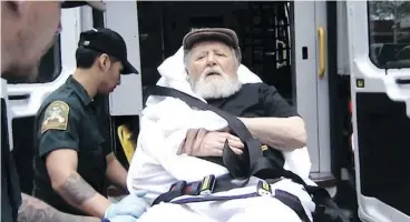  ?? ABC VIA THE ASSOCIATED PRESS ?? Jakiw Palij, a former Nazi concentrat­ion camp guard, is carried on a stretcher from his home in New York into a waiting ambulance on Monday.