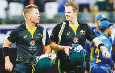  ?? Agence France-presse ?? ↑
Australia’s David Warner and Steve Smith leave the field after victory against Sri Lanka at the second Twenty20 match on Wednesday.