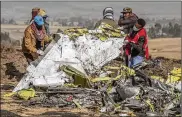  ?? MULUGETA AYENE / ASSOCIATED PRESS ?? Rescue teams work at the scene of the Ethiopian Airlines plane crash near Bishoftu, south of Addis Ababa, Ethiopia, on Monday.