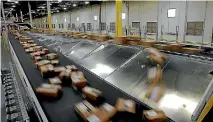  ?? PHOTO: REUTERS ?? While Amazon has no property in New Zealand for distributi­on, New Zealand Post has recently opened two new processing facilities.
