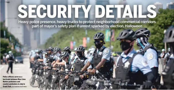  ?? PATNABONG/SUN-TIMES ?? Police officers serve as a barricade between Blue Lives Matter protesters and counter-protesters in July in Grant Park.