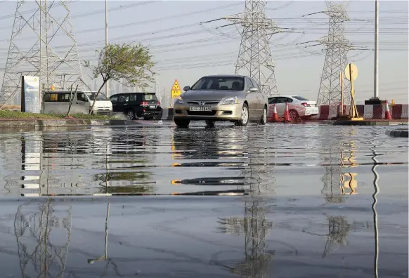  ?? Pawan Singh / The National ?? Water covering roads in Discovery Gardens of Dubai, after rain early yesterday