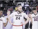  ?? YOUNG KWAK/ THE ASSOCIATED PRESS ?? Gonzaga guard Jordan Mathews (4), center Przemek Karnowski (24) and forward Zach Collins (32), a Bishop Gorman High product, stand on the court during a senior night presentati­on Saturday in Spokane, Washington. The then-top-ranked Bulldogs went on to...