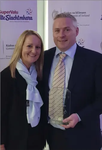  ??  ?? Jason Mulhall collecting his award in the Helix in Dublin with his wife Louise.