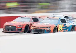  ?? JAMES GILBERT/GETTY ?? Joey Logano and William Byron (24) drive side by side during Sunday’s NASCAR race. Logano sent Byron into the wall on the next-to-last lap en route to the victory.