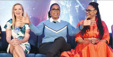  ?? ALBERTO E. RODRIGUEZ/GETTY IMAGES ?? Reese Witherspoo­n, left, Oprah Winfrey and Ava DuVernay discuss their new project, A Wrinkle in Time.