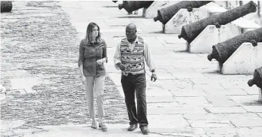  ?? Saul Loeb / AFP/Getty Images ?? First lady Melania Trump tours the Cape Coast Castle, a former slave trading fort, in Cape Coast, Ghana, on Wednesday with museum educator Kwesi Essel-Blankson. “It’s very emotional,” Trump said.