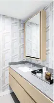  ??  ?? Bathroom cabinetry is by Friul Intagli, with stone slab countertop­s and undermount ceramic basins.