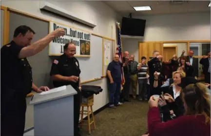  ?? BRIANA CONTRERAS — THE MORNING JOURNAL ?? Amherst Police Department officers, employees and community supporters of Amherst Patrolman Eugene “JR” Ptacek, said a toast welcoming back the officer, Nov. 8, during a celebratio­n at the department. Ptacek is working his way to recovery and return to the station after suffuring a gunshot wound May 31.