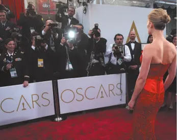  ?? CITIZEN NEWS SERVICES PHOTO ?? In this 2015 file photo, actress Rosamund Pike arrives at the Oscars in Los Angeles. There are two paths on the Oscars red carpet: one for famous people, and one for everyone else.