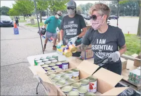  ?? PHOTO COURTESY OF JENNIE MILLER ?? Gleaners volunteers box up non-perishable food for southeast Michigan children in need.