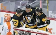  ?? KEITH SRAKOCIC — THE ASSOCIATED PRESS ?? Pittsburgh Penguins’ Evgeni Malkin, center, celebrates with Sidney Crosby (87), and Bryan Rust (17) after scoring on Philadelph­ia Flyers goaltender Brian Elliott (37) during the first period of an NHL hockey game, Saturday, March 6, 2021, in Pittsburgh.