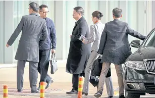  ?? AP ?? Song Tao, centre, the head of China’s ruling Communist Party’s Internatio­nal Liaison Department, arrives at Beijing Capital Internatio­nal Airport in Beijing, yesterday.