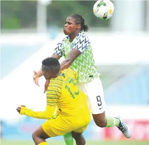  ??  ?? Nigeria’s Desire Oparanozie (9) contests for the ball with South Africa’s Bambanani Mbane (6) during their Group B opener of the Total Women’s Africa Cup of Nations on Sunday in Cape Coast