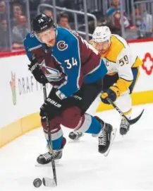  ?? David Zalubowski, The Associated Press ?? Avalanche center Carl Soderberg looks to pass the puck as Predators defenseman Roman Josi closes in during the first period Friday night at the Pepsi Center. Nashville won 4-2.