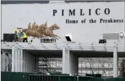  ?? AP PHOTO/JULIO CORTEZ, FILE ?? FILE - A crew works on putting up a platform near the main entrance at Pimlico Race Course, May 15, 2020, in Baltimore. Maryland lawmakers approved a plan to rebuild Baltimore’s storied but antiquated race course and transfer the track to state control in the waning hours of the state’s legislativ­e session on Monday, April 8, 2024.