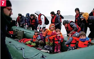  ?? ?? Looking frightened and confused, children are loaded into the dinghy 7