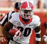  ?? CURTIS COMPTON / CCOMPTON@AJC. COM ?? Georgia defensive back J.R. Reed returns an intercepti­on during the Bulldogs’ 41-0 rout of Tennessee. Reed, a sophomore transfer, has made an impact on a defense stocked with experience.