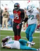  ?? WILFREDO LEE — THE ASSOCIATED PRESS ?? Miami QB Jay Cutler (6) takes his time getting up after he was sacked Sunday in Miami Gardens, Fla. Dolphins guard Jesse Davis (77) and Bucs defensive end Ryan Russell (95) stand over Cutler.