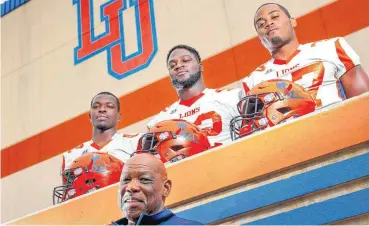  ?? [PHOTO BY BRYAN TERRY, THE OKLAHOMAN] ?? Calvin Miller stands with three of his Langston University defensive players, from left, Tyler Bless, Jamarae Finnie and Michael Smith.