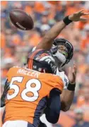  ?? JACK DEMPSEY/AP ?? Seahawks quarterbac­k Russell Wilson fumbles after being hit by Broncos linebacker Von Miller.