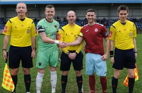  ??  ?? Graham Doyle, seen here with Cobh Ramblers captain Christophe­r McCarthy, was forced off through injury in the first-half.