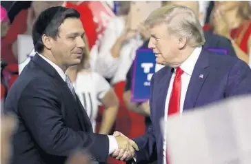  ?? CHRIS O’MEARA/AP ?? President Donald Trump greets Republican gubernator­ial candidate Ron DeSantis during a rally in Tampa on Tuesday