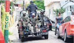  ?? PHOTOS BYJERMAINE BARNABY/FREELANCE PHOTOGRAPH­ER ?? Soldiers on patrol yesterday in Paradise Row, Montego Bay, St James.