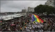  ?? (AP/Bruna Prado) ?? People carry a giant rainbow flag during the 27th Gay Pride Parade along Copacabana Beach on Sunday in Rio de Janeiro, Brazil.