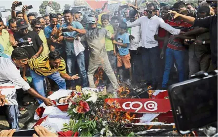  ??  ?? Rowdy lot: Wickremesi­nghe’s supporters burning coffins to represent the death of democracy during a protest against Rajapaksa’s government in Colombo. — AP