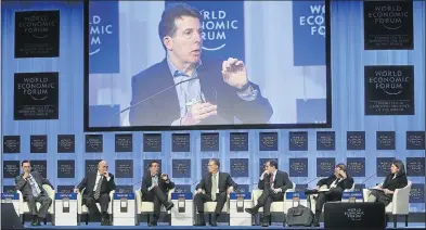  ?? Picture: REUTERS ?? BIG HITTER: Robert Diamond, shown here third from left and on the big screen, says his experience gleaned on Canary Wharf and on Wall Street has prepared him to overcome the inevitable obstacles that come with banking on the world’s poorest continent.