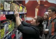  ?? PHOTOS BY RICK KAUFFMAN – DIGITAL FIRST MEDIA ?? A Wawa associate gives recommenda­tions on the sixpacks of beer in the new section at the Concord location on Naaman’s Creek Road.