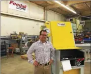  ?? BILL DEBUS — THE NEWS-HERALD ?? Jon Cocco, owner and CEO of Feedall Automation in Willoughby, displays a feeder machine built by the company.