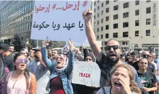  ??  ?? Demonstrat­ors chant slogans and carry banners during a protest against corruption and deteriorat­ing economic conditions, in front of the government palace in Beirut on Sept 29. The banner reads: “Government and ruling class, leave”.