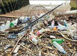  ?? AP file photo ?? Bottles and other plastics, including a mop, litter the site of the ancient and no-longer used Queenhithe dock on the River Thames in London recently.