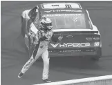  ?? DOUG MCSCHOOLER/AP ?? AJ Allmending­er celebrates at the finish line after winning Sunday’s NASCAR Cup Brickyard 200 at Indianapol­is Motor Speedway in Indianapol­is.