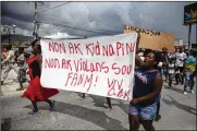  ?? JOSEPH ODELYN / AP ?? Protesters carry a banner that reads in Creole: “No to kidnapping­s, no to violence against women! Long live Christian Aid Ministries.”