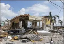  ?? ALAN DIAZ - THE ASSOCIATED PRESS ?? In this Sept. 13 photo, debris surrounds a destroyed structure in the aftermath of Hurricane Irma in Big Pine Key, Fla. Rising sea levels and fierce storms have failed to stop relentless population growth along U.S. coasts in recent years, a new...