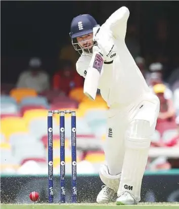  ?? AP ?? Above: England’s James Vince plays a cover drive on the first day of the first Ashes Test against Australia in Brisbane yesterday. Right: Australia’s Pat Cummins celebrates the wicket of England captain Joe Root. The visitors were 196 for four at stumps.