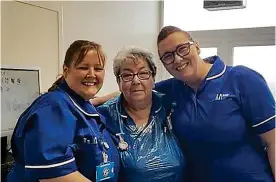  ??  ?? Long service: Nurse Liz Glanister (centre) with colleagues at Aintree hospital