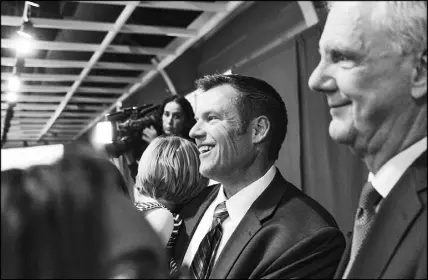  ?? BARRETT EMKE / THE NEW YORK TIMES ?? Kris Kobach, center, gathers with supporters Nov. 6 to watch election returns in Topeka, Kan. Fresh from his defeat in the race for Kansas governor, Kobach, the former Kansas secretary of state, is involved with a project to raise private funds to build a wall on the southern border.