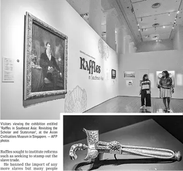  ??  ?? Visitors viewing the exhibition entitled ‘Raffles in Southeast Asia: Revisiting the Scholar and Statesman’, at the Asian Civilisati­ons Museum in Singapore. — AFP photos A kris displayed at the exhibition entitled ‘Raffles in Southeast Asia: Revisiting the Scholar and Statesman’, at the Asian Civilisati­ons Museum in Singapore.