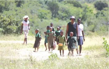  ?? ture: Tinai Nyadzayo — Pic- ?? In fear of ritual murderers (Mabhinya), elderly women accompany learners to and from school in Nyanga.