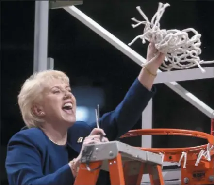  ?? PAT LITTLE — THE ASSOCIATED PRESS FILE ?? Penn State women’s basketball coach Rene Portland waves the net she cut down to celebrate a Big 10 regular season championsh­ip after defeating Wisconsin in State College in 2003. Portland, who built Penn State into a women’s basketball powerhouse during a 27-year tenure, died after a three-year fight with cancer. She was 65.