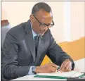  ?? Picture: AFP/STR ?? COMMITMENT SIGNAL: Rwandan President Paul Kagame signs the African Continenta­l Free Trade Area agreement during the AU summit in Kigali, Rwanda